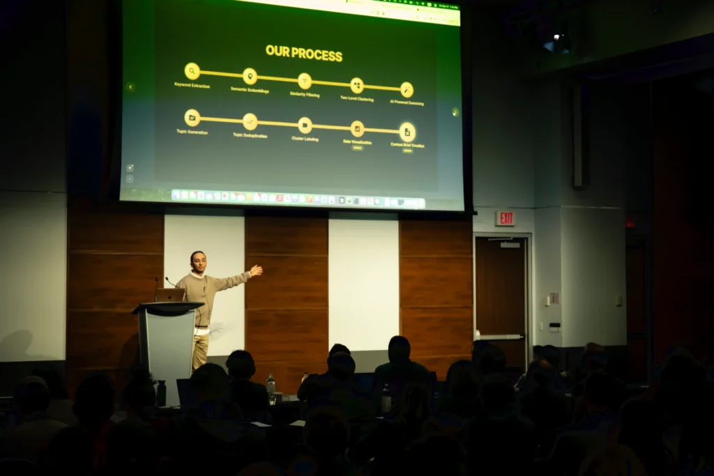 Amin Foroutan on stage with the 10-step process slide at SEO IRL 2025.